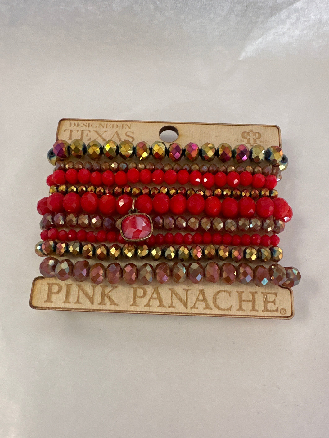 Pink panache, nine strand red bracelet stack